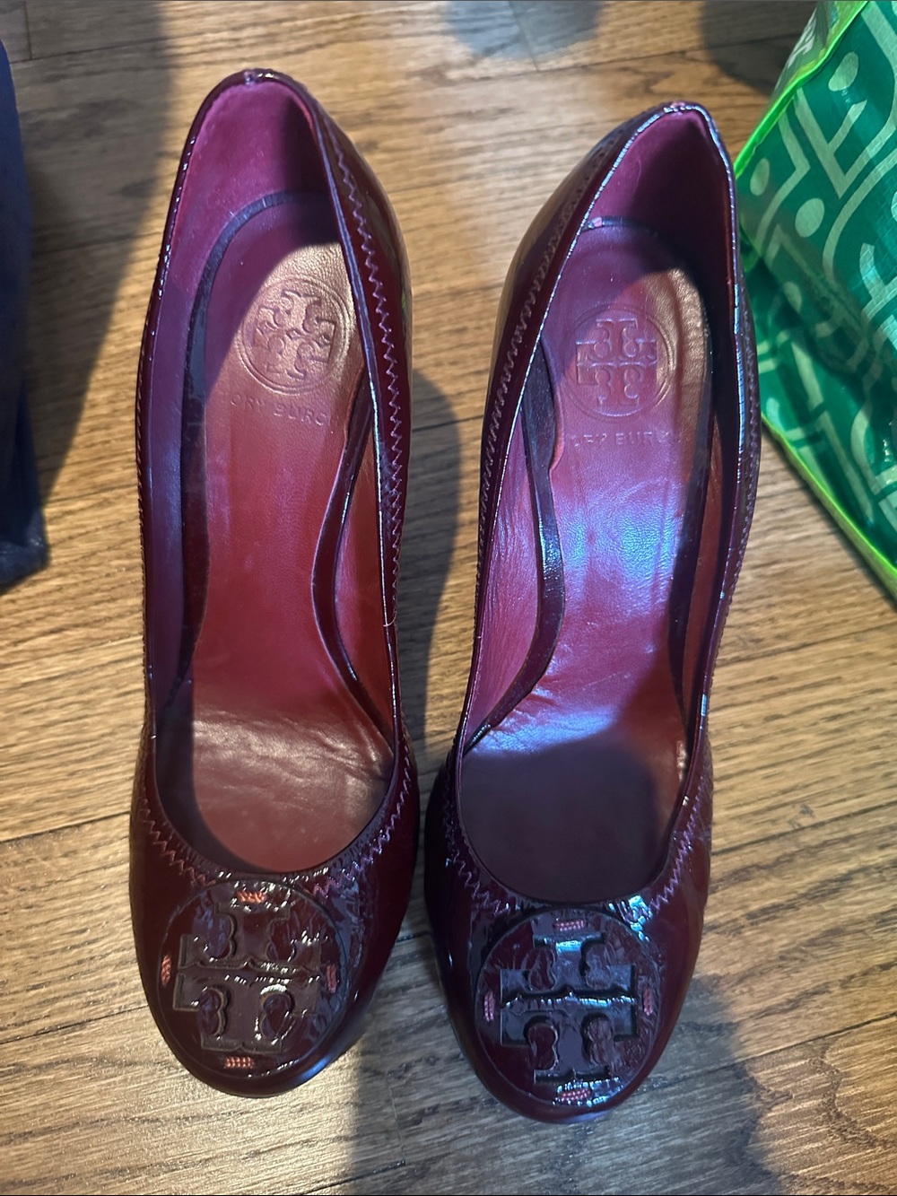 Tory Burch Wine Patent Leather Round-Toe Pumps with Logo Medallion